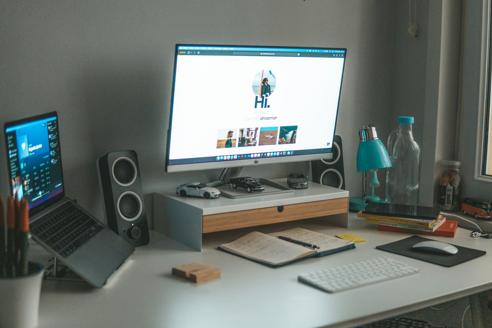 a desk with a computer and a laptop on it